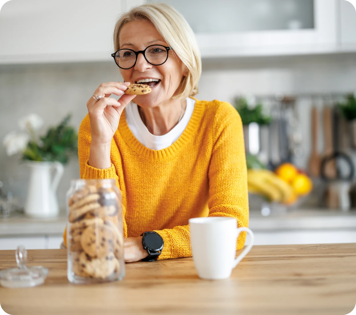 Woman in yellow sweater with cookies